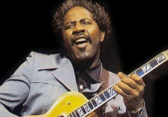 Fenton Robinson on stage playing guitar