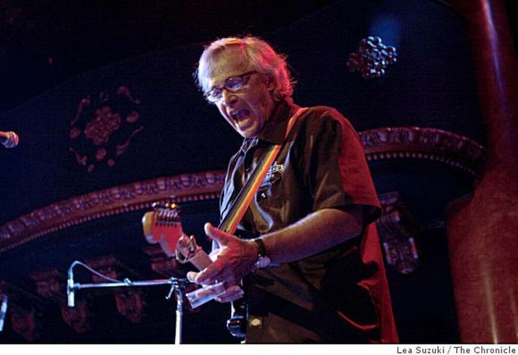 Ry Cooder Live playing guitar on stage